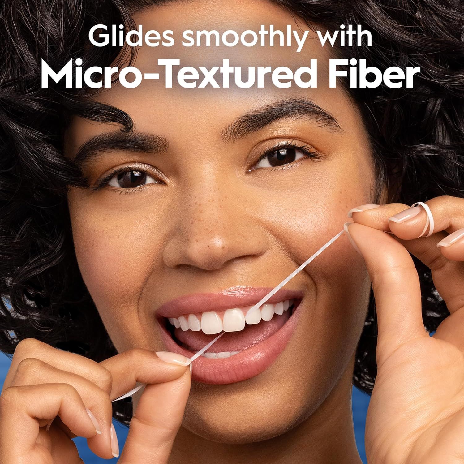 Highlights the product's micro-textured fiber technology that allows the dental floss to glide smoothly between teeth, emphasizing ease of use and comfort.