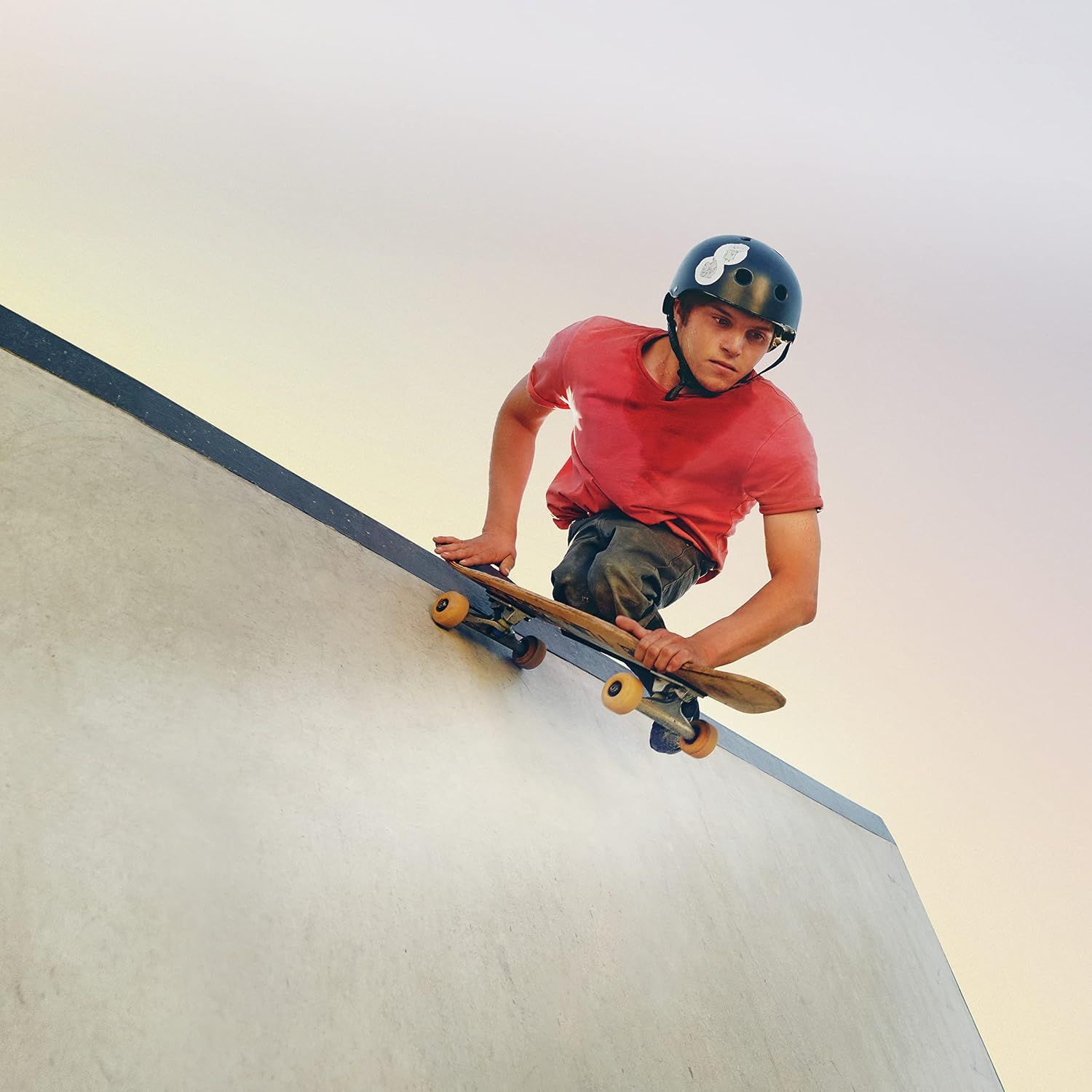 Showcases the product (helmet or skateboard) being used in a real-world skateboarding environment to help shoppers visualize the product in action and connect emotionally with the activity.