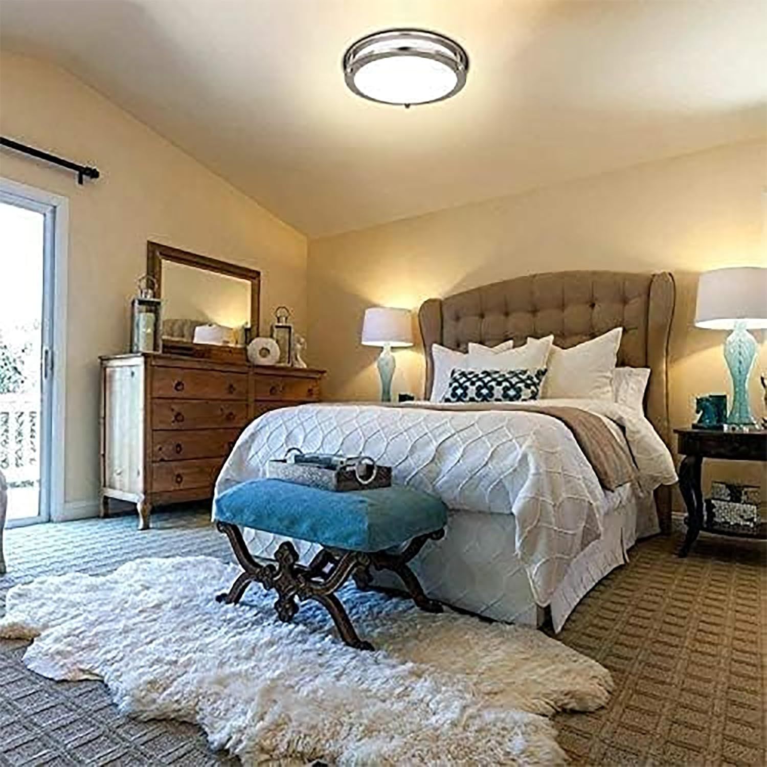 Demonstrates the ceiling light fixture installed and illuminated in a real bedroom environment to help shoppers visualize how the product looks and performs in an actual living space.