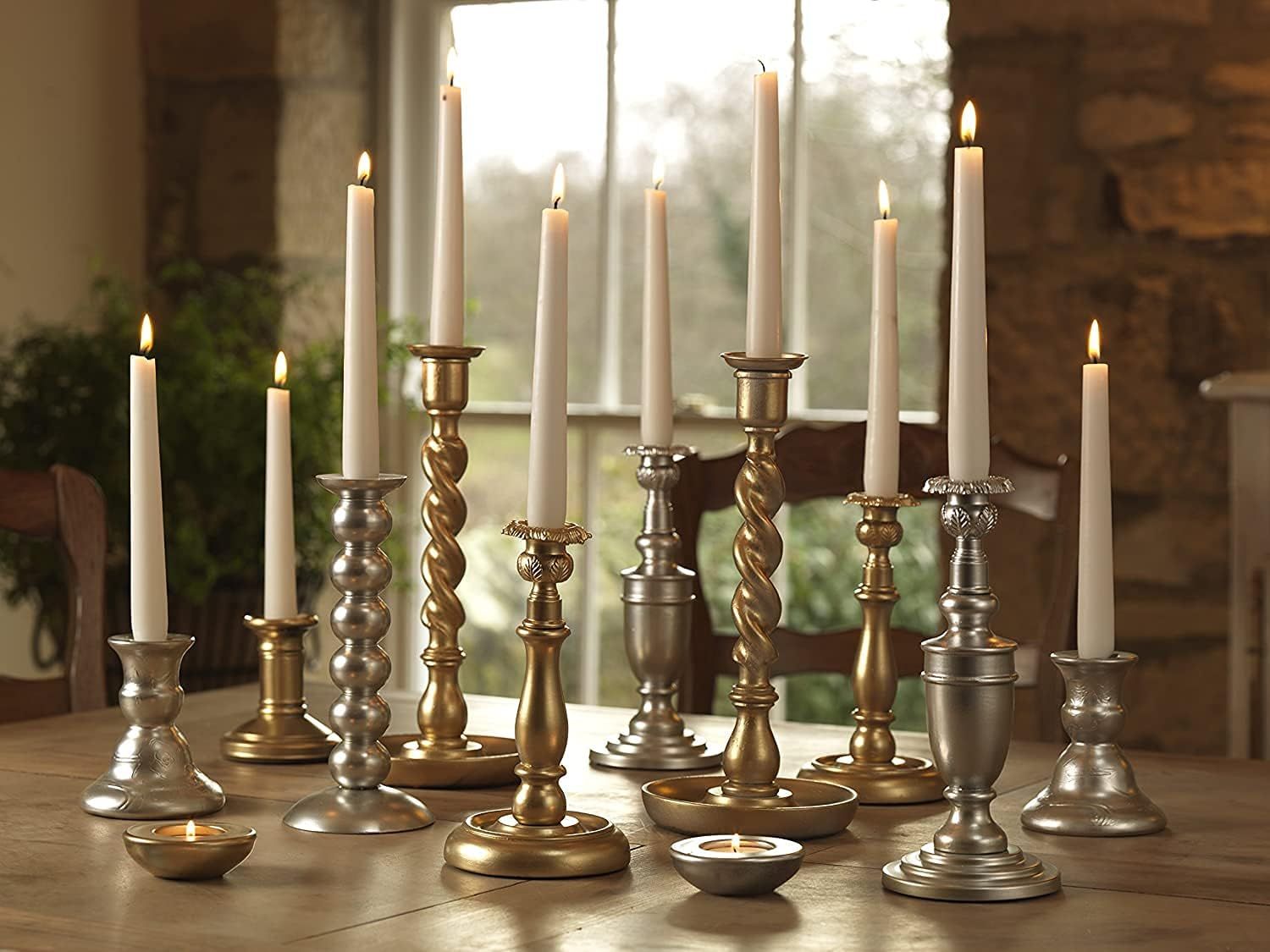 Showcases the product in an elegant real-world home setting to help shoppers visualize how the candlesticks would look styled in their own space.