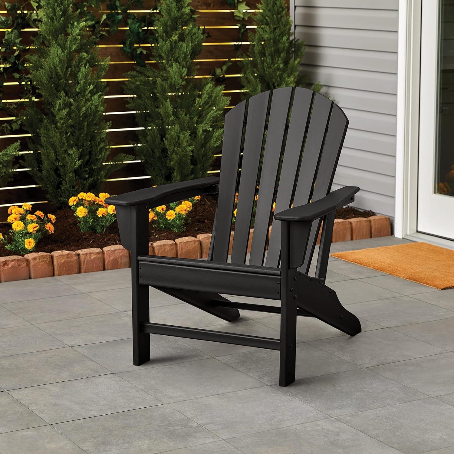 Showcases the product in a real-world outdoor patio setting to help shoppers visualize how the chair would look and fit in their own outdoor space.
