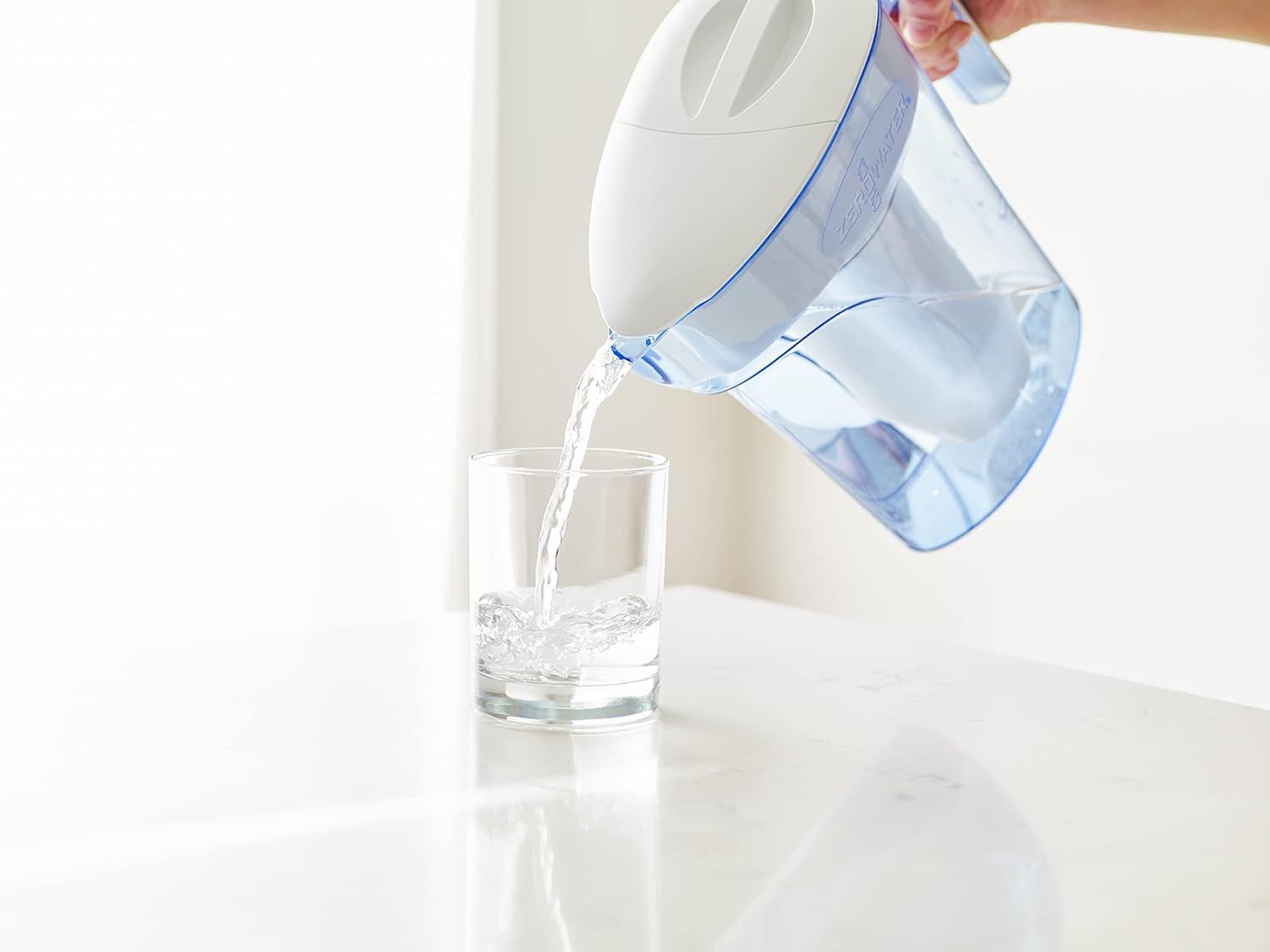Demonstrates the water filter pitcher being used in a real-world home setting, showing the product in action to help shoppers visualize everyday use.