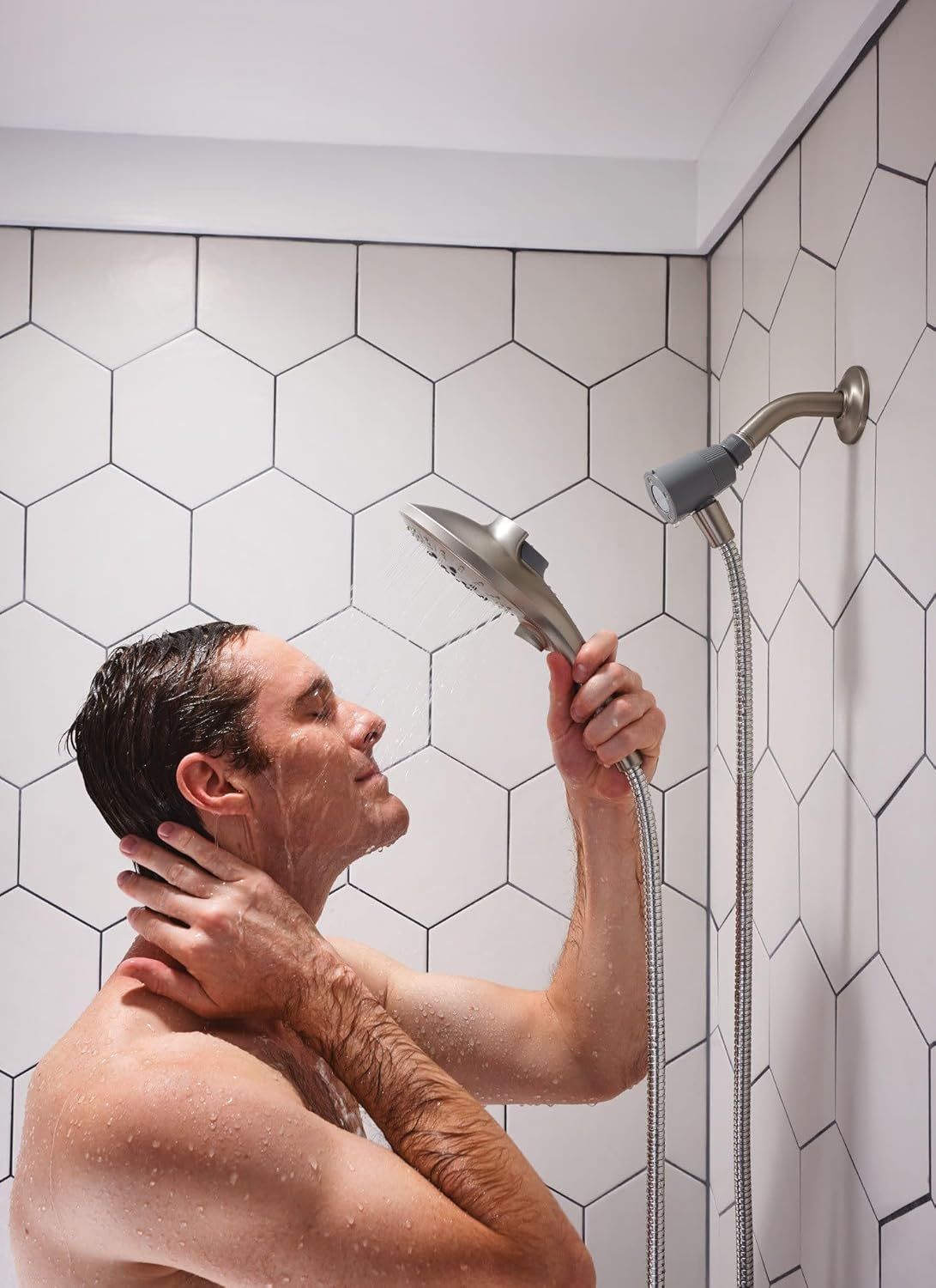 Demonstrates the product in a real-world bathroom setting to help shoppers visualize the handheld showerhead in actual use and understand its functionality.