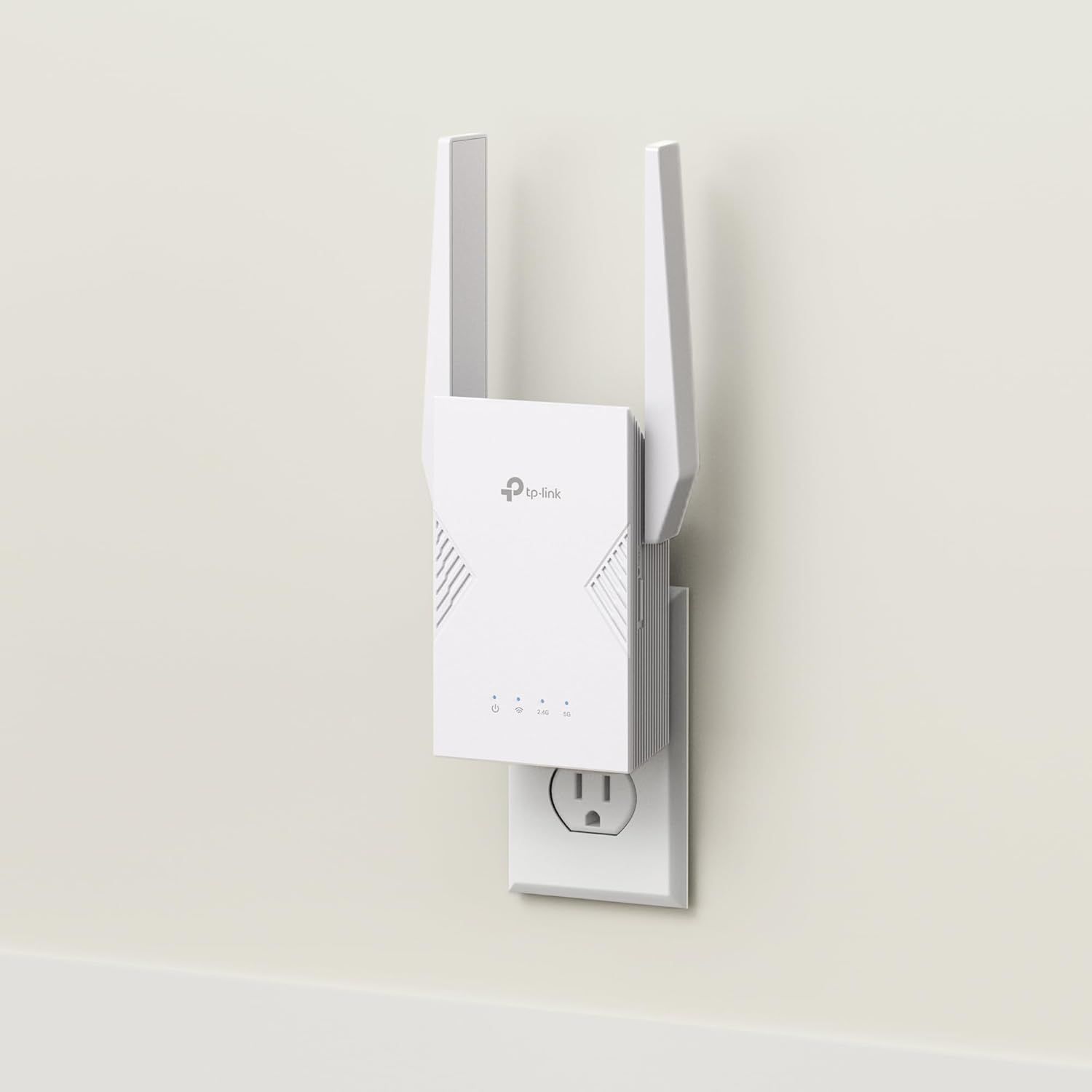 Shows the TP-Link WiFi extender plugged into a wall outlet in a real-world home setting, helping shoppers visualize how the product looks and fits in their space.