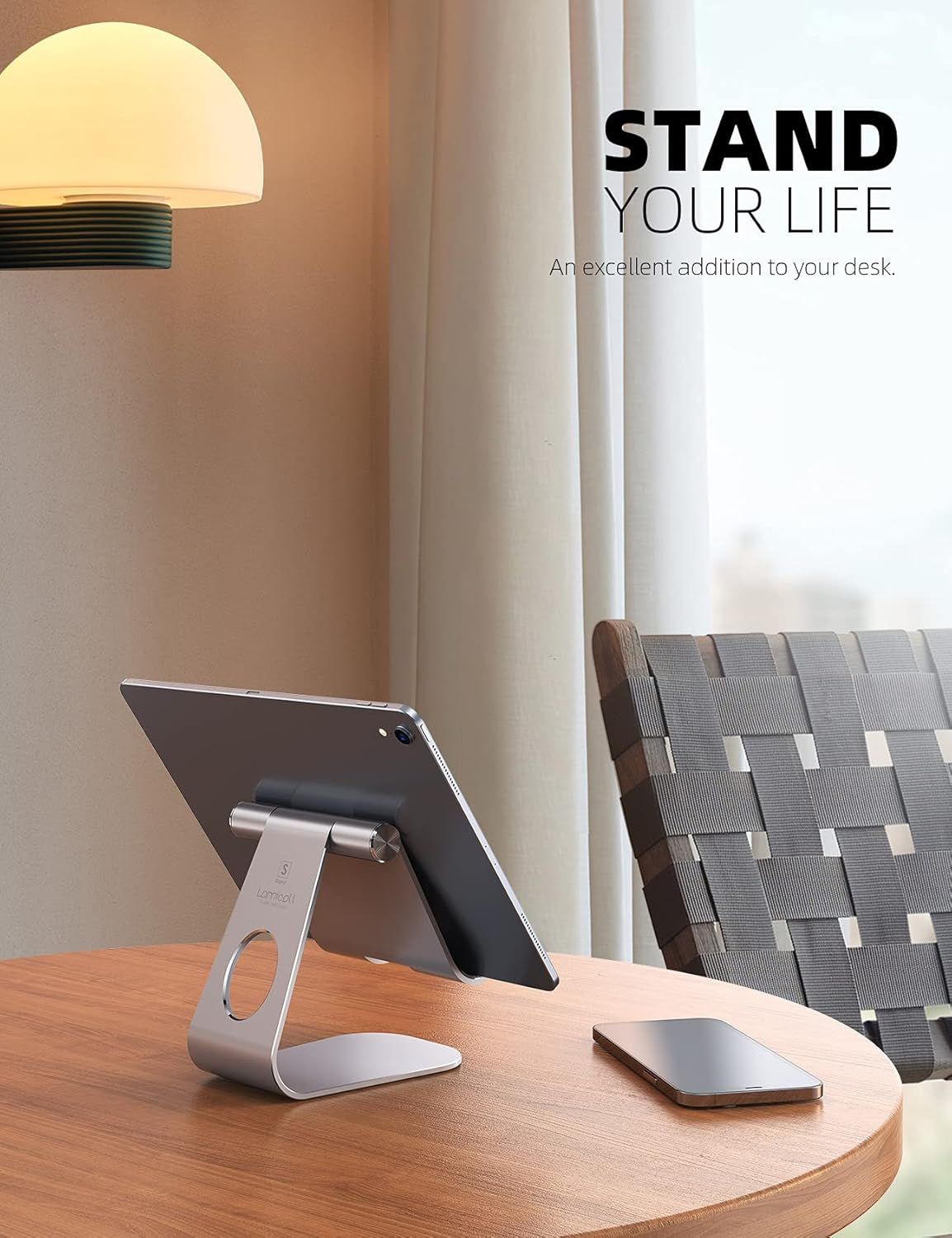 Demonstrates the product in a real-world office or home setting to help shoppers visualize how the tablet stand fits into their workspace and lifestyle.