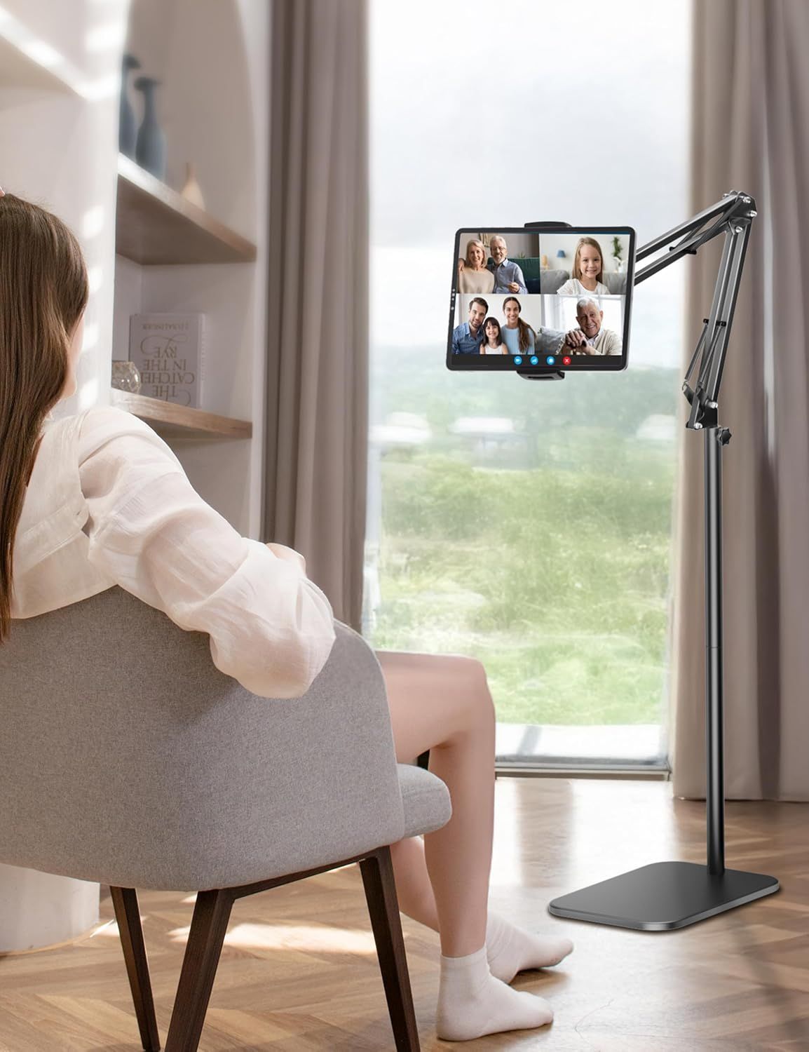 Demonstrates the product in a real-world home setting during a video call, showing how the adjustable stand enables comfortable, hands-free video conferencing with family or friends.