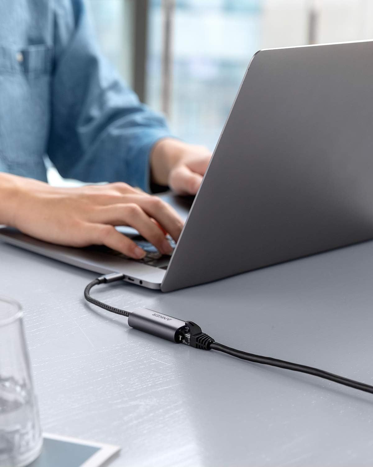 Demonstrates the product being used in a real-world office setting to help shoppers visualize how the adapter/cable integrates into their daily workflow.