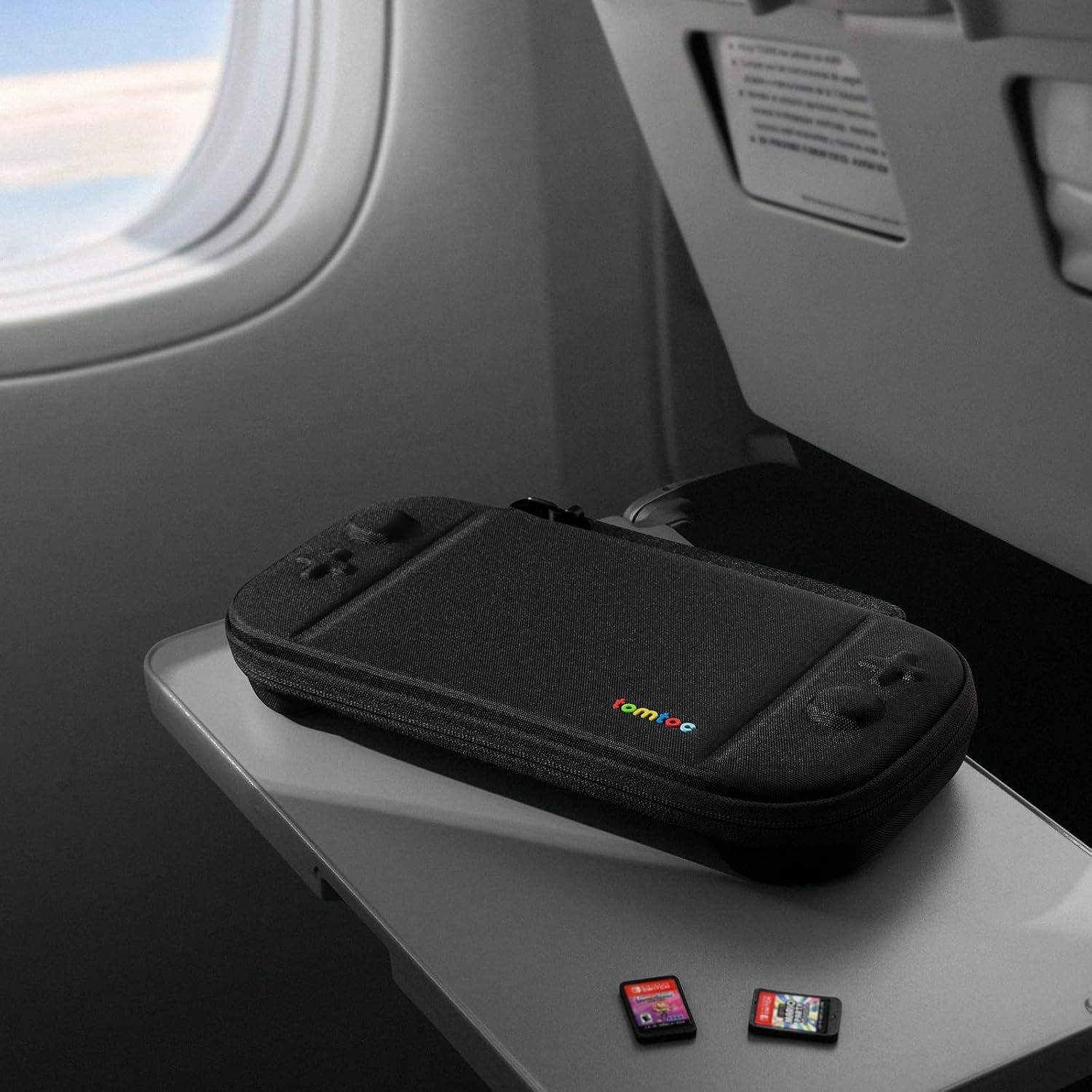 Demonstrates the product in a real-world travel context (airplane tray table) to show its portability and suitability for on-the-go use.