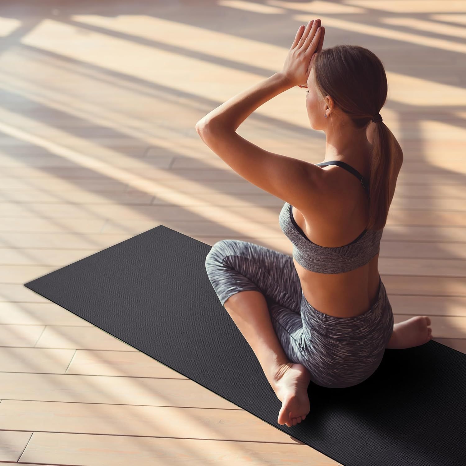 Demonstrates the product in a real-world yoga/meditation setting to help shoppers visualize themselves using the mat in their own practice.