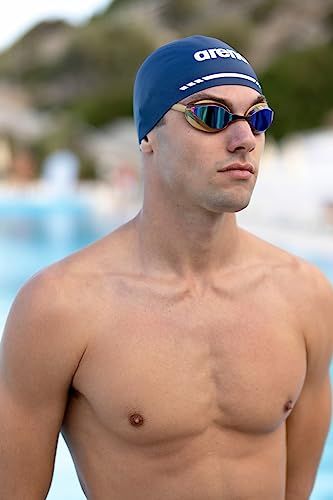 Demonstrates the product (swim cap and goggles) being worn in a real-world swimming environment to help shoppers visualize the product in use.
