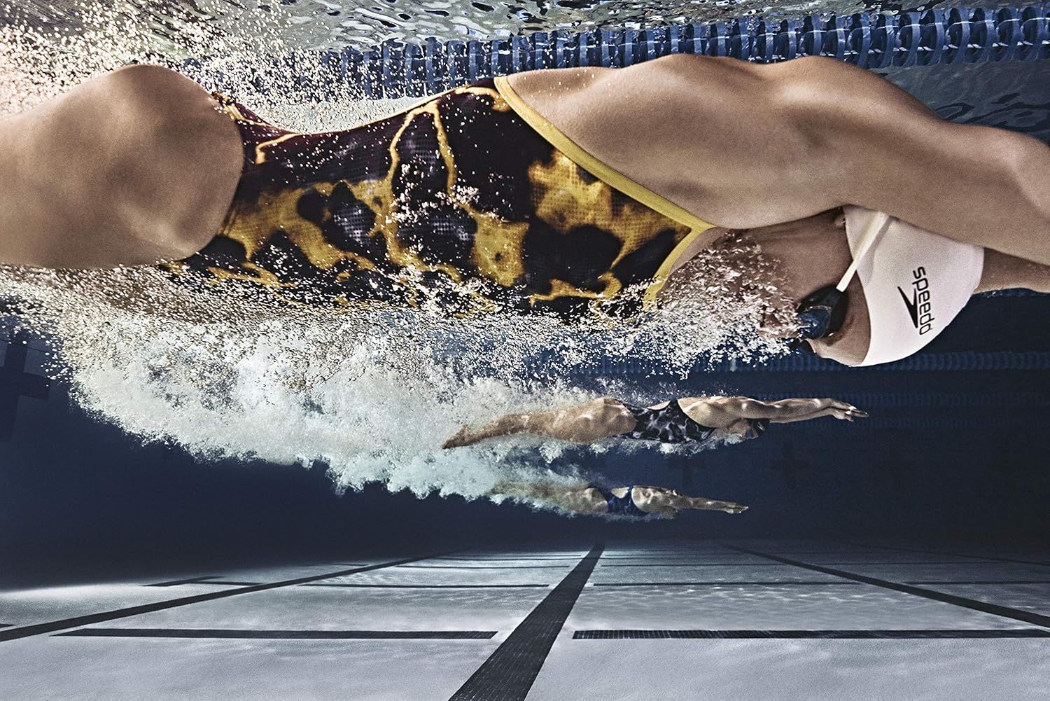 Demonstrates the product in action during competitive swimming to show its real-world athletic performance and appeal to serious swimmers.