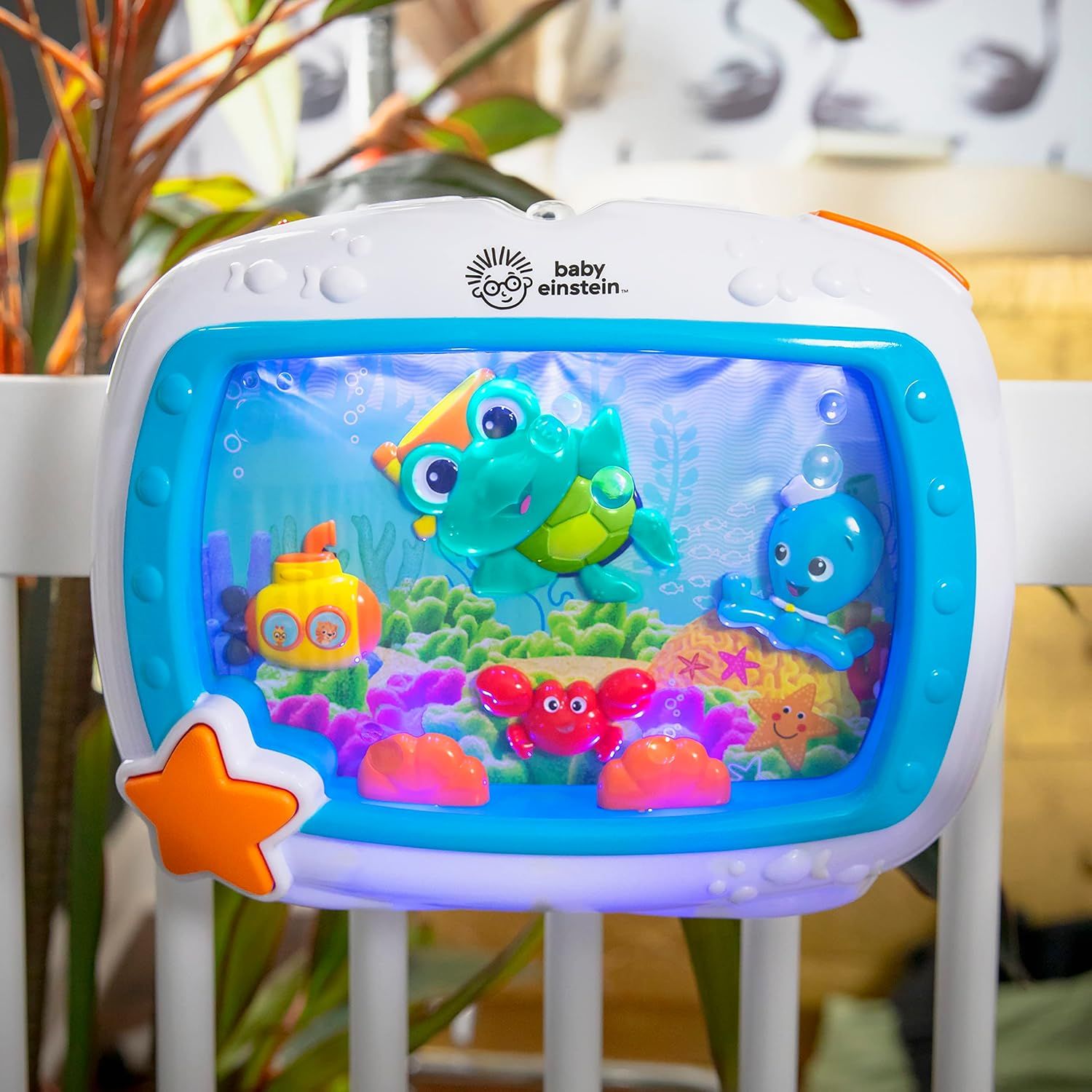 Displays the Baby Einstein aquarium toy in a clean, lifestyle setting to show the product's appearance and colorful underwater scene design.