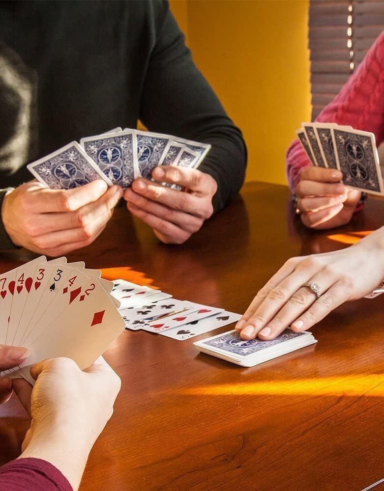 Demonstrates the product (playing cards) being used in a real-world social setting to show its application for family game nights and entertainment.