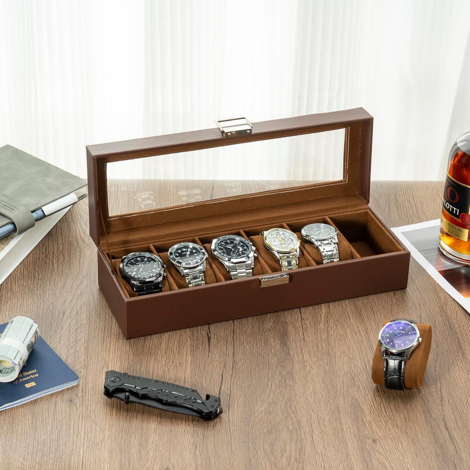 Showcases the product in a real-world lifestyle setting to help shoppers visualize how the watch case organizes and displays their collection in an elegant home or office environment.