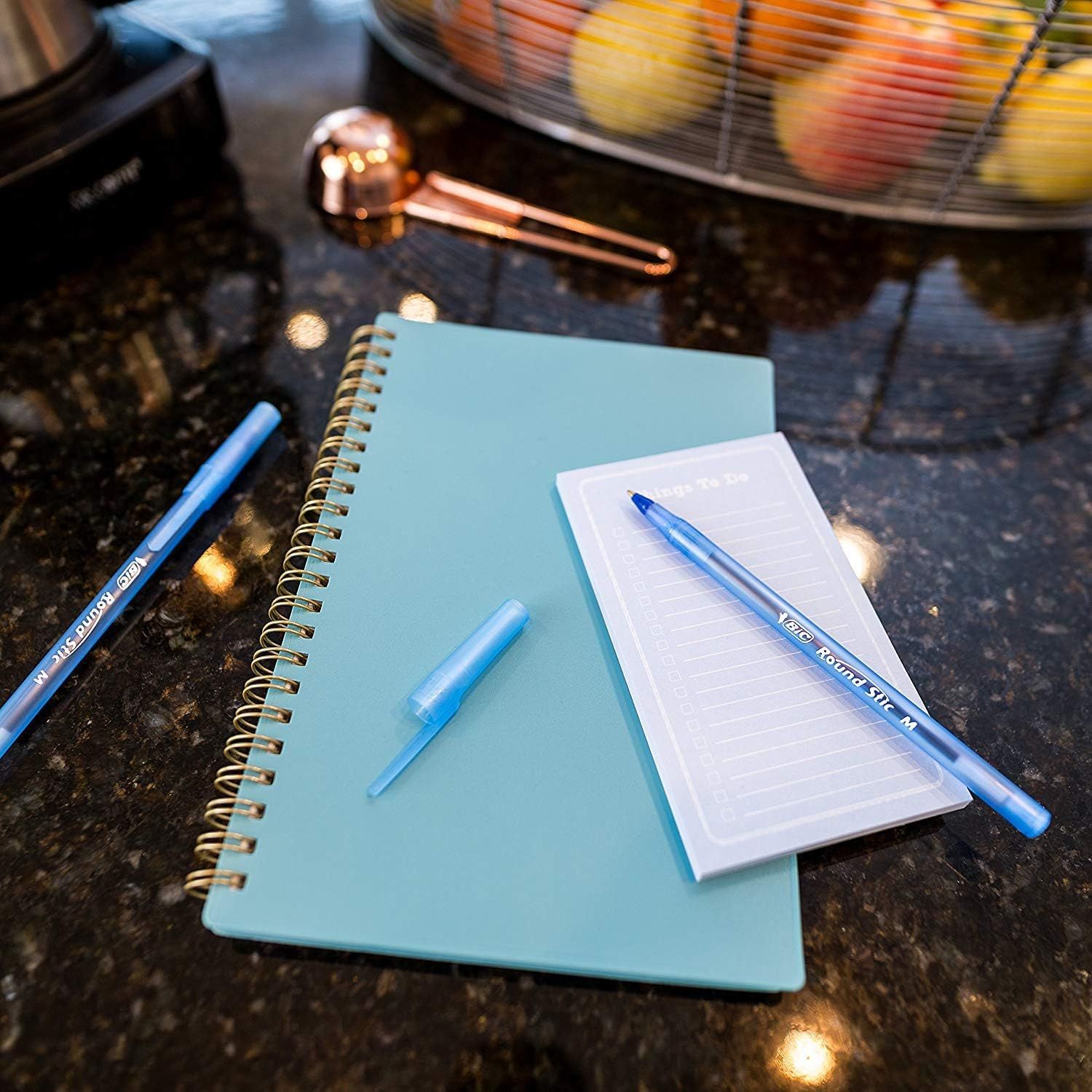 Shows the product in an authentic home environment to help shoppers visualize how the pens and notebooks would look and function in their daily life.