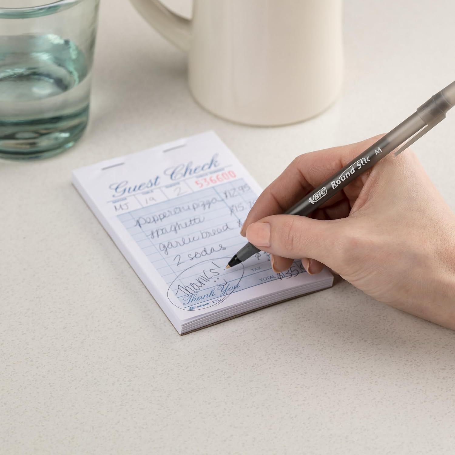 Demonstrates the product being used in an authentic, real-world setting to help shoppers visualize how they would use the guest check notepad in their own…