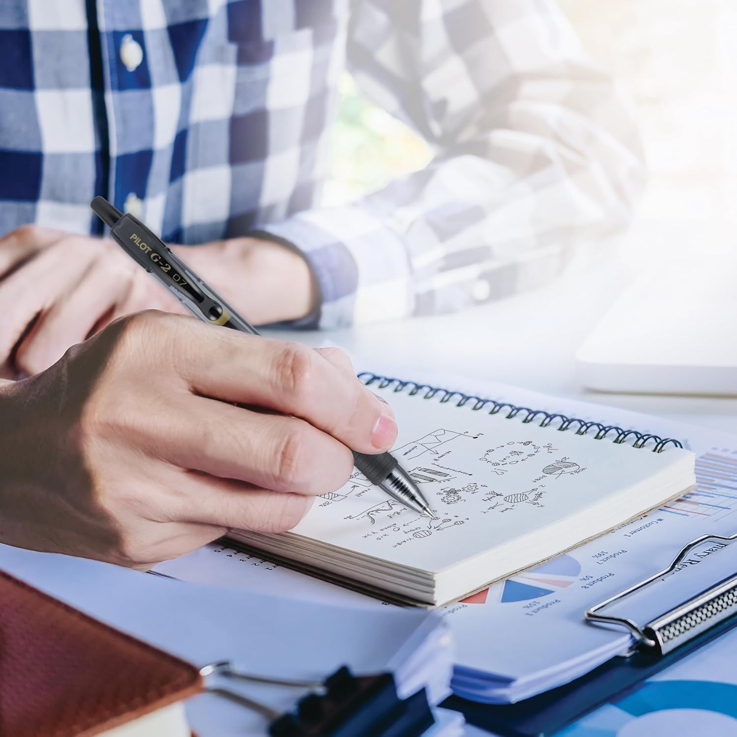 Demonstrates the product (pen) in a real-world professional context, showing it being used for note-taking and business work to help shoppers visualize…