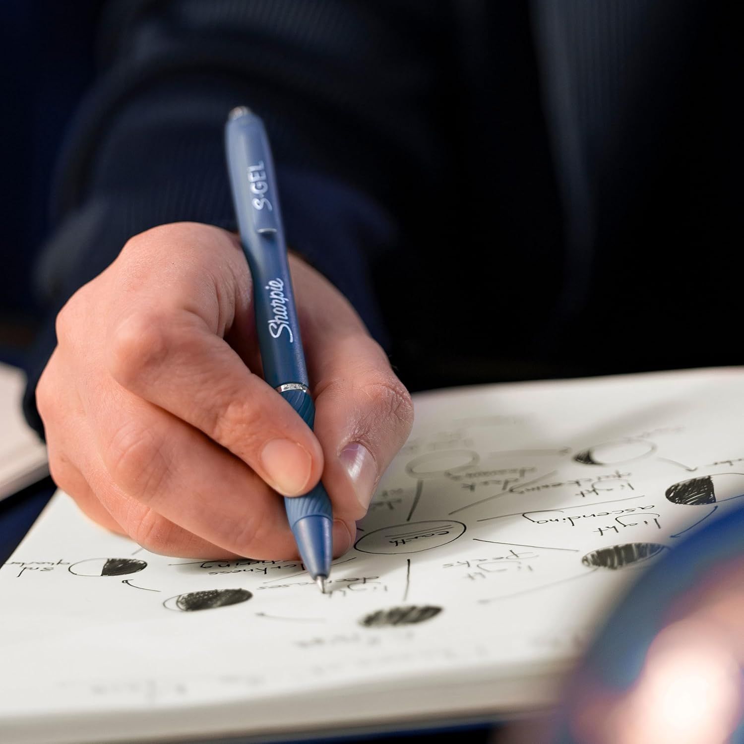 Shows the product being used in a real-world setting to help shoppers visualize how they would use the pen in their daily life.