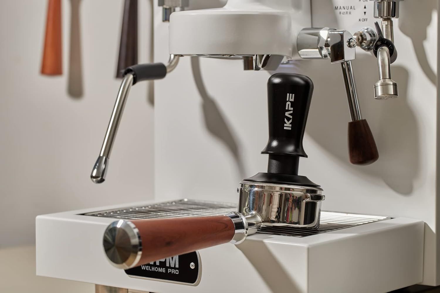 Shows the tamper positioned on an espresso machine in a home barista setting, helping shoppers visualize how the product fits into their coffee routine.