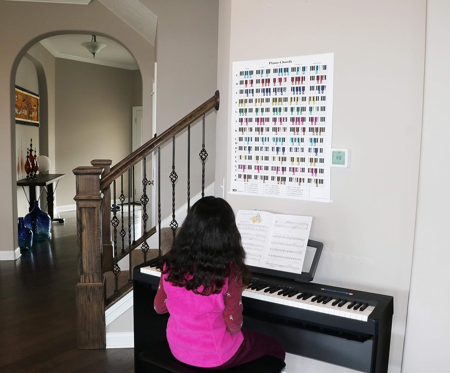 Demonstrates the poster being used by a child during piano practice to show its educational value and real-world application for learners.