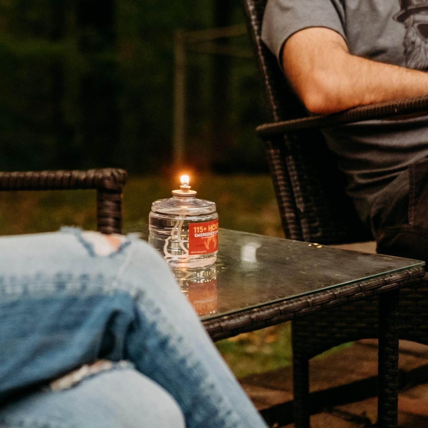 Shows the emergency candle in use within a real-world outdoor evening setting to help shoppers visualize the product in a natural context.