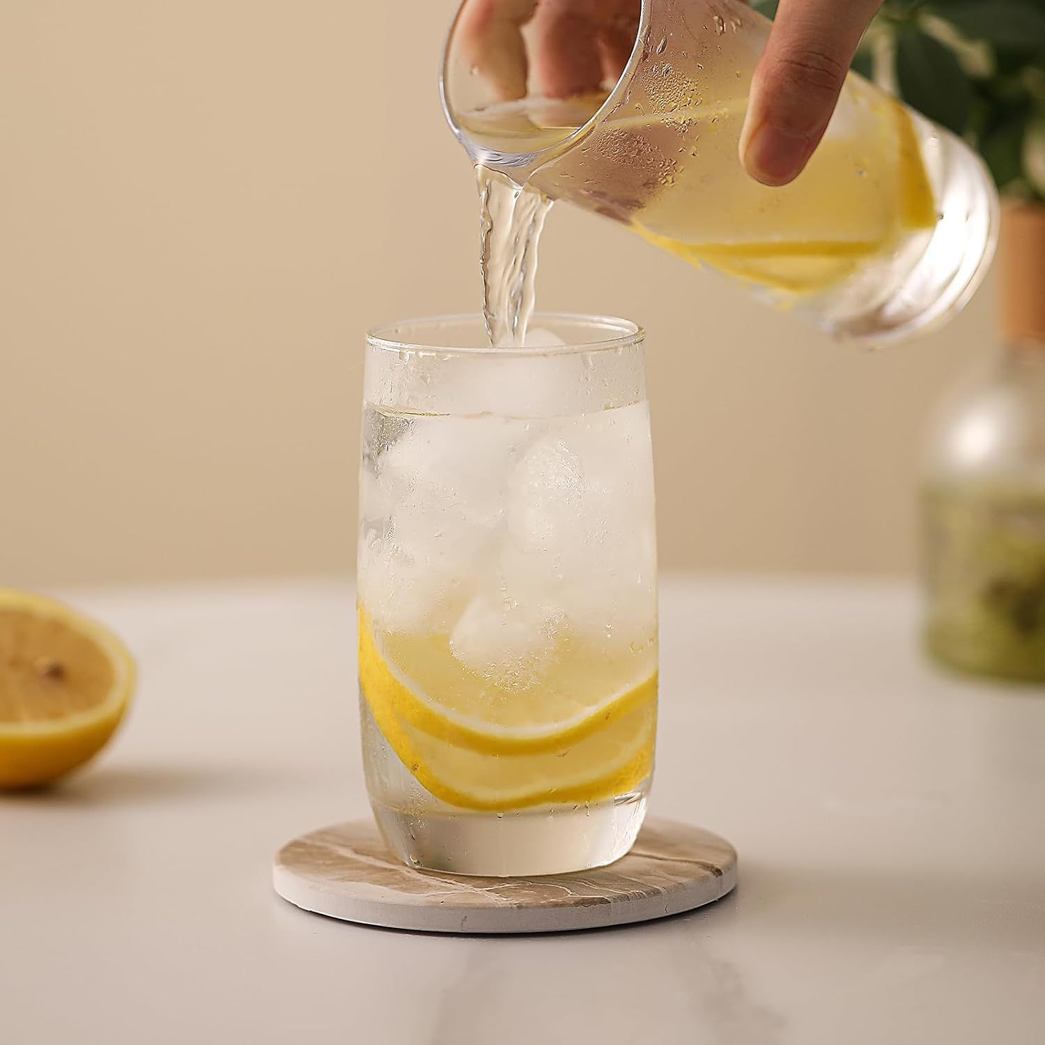 Shows the coasters being used in a real-world setting with beverages to help shoppers visualize the product in their own home.