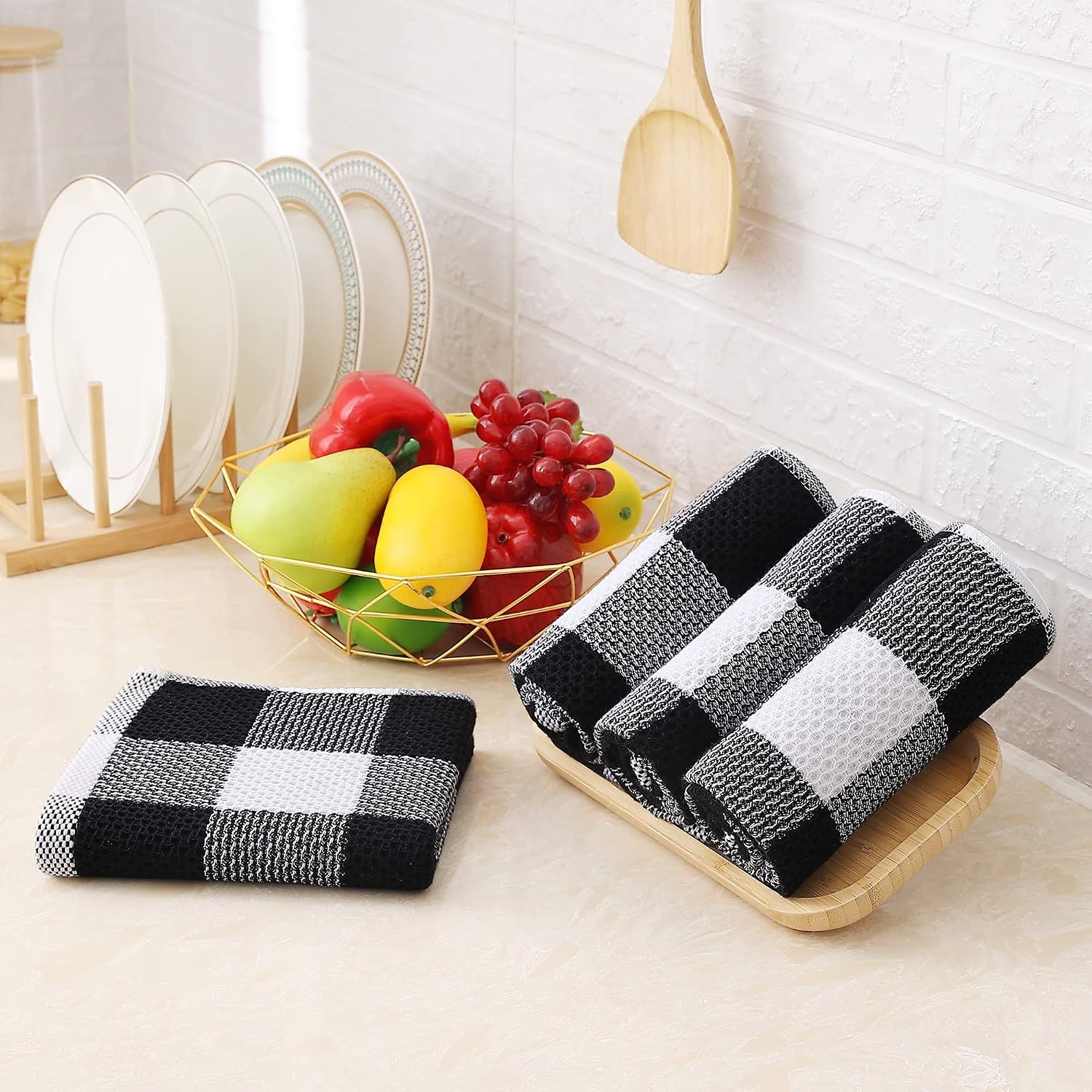 Shows the product in a real kitchen environment to help shoppers visualize how the towels will look and fit in their own home.