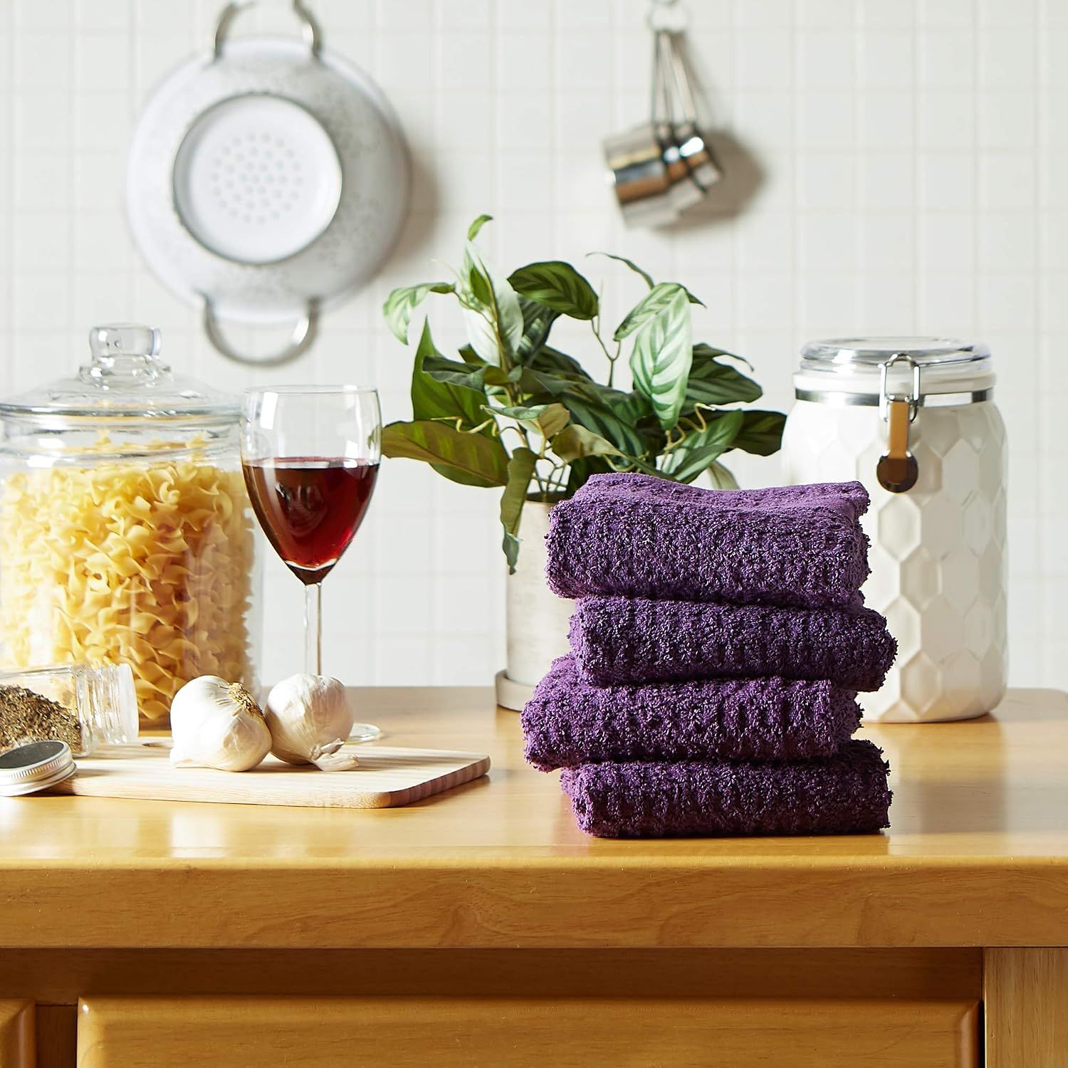 Shows the towels in a real kitchen environment to help shoppers visualize the product in their own home.