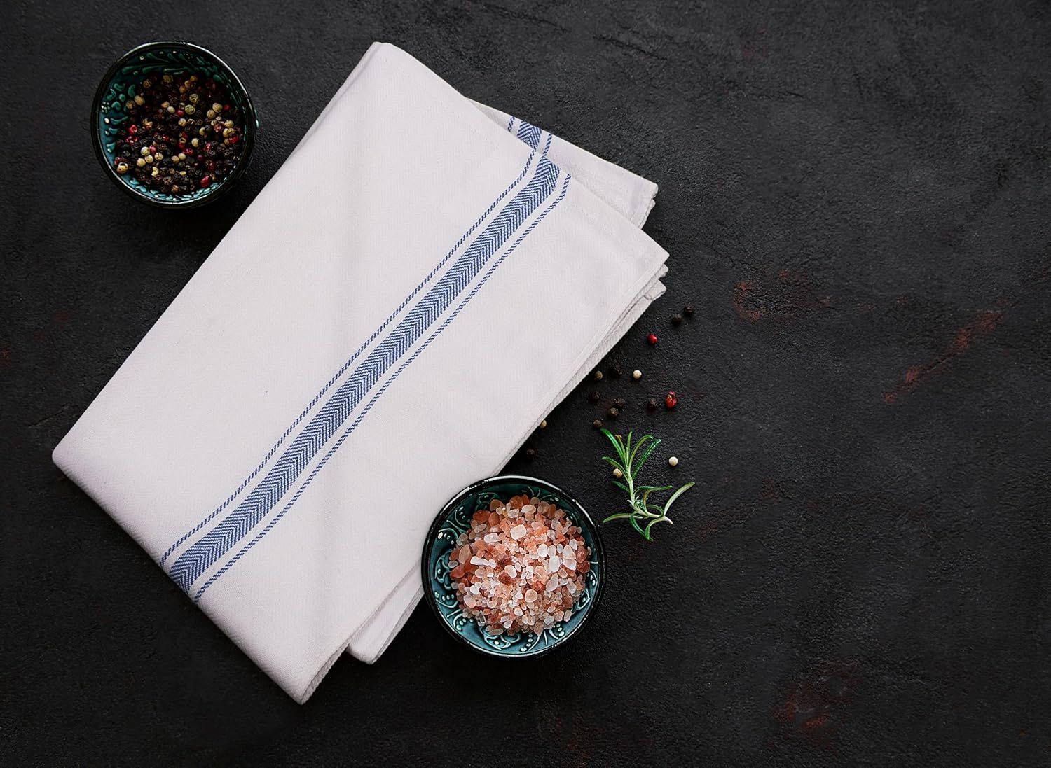 Presents the product in a styled kitchen environment with culinary elements to convey quality and aesthetic appeal.