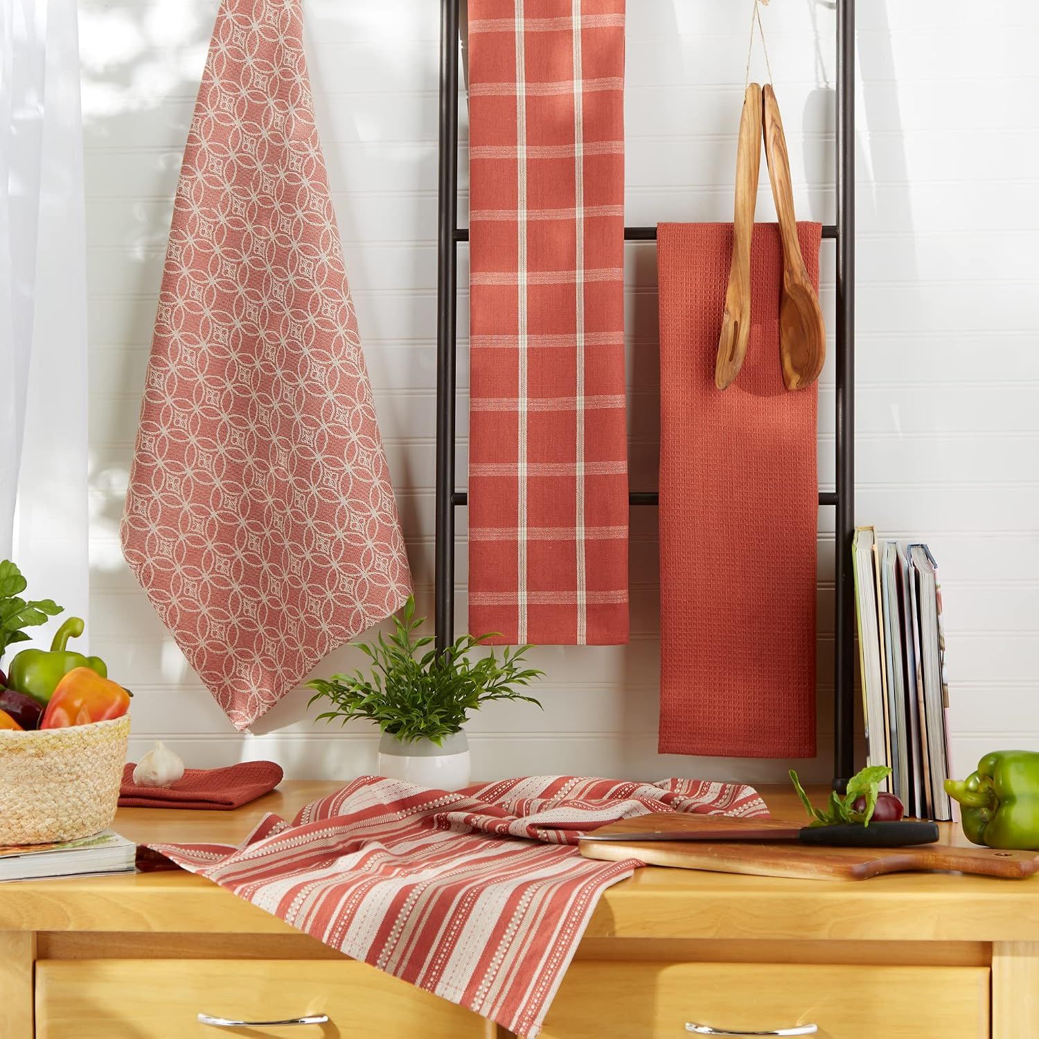 Shows the dishtowels hanging and displayed in a real kitchen environment to help shoppers visualize how they look in use.