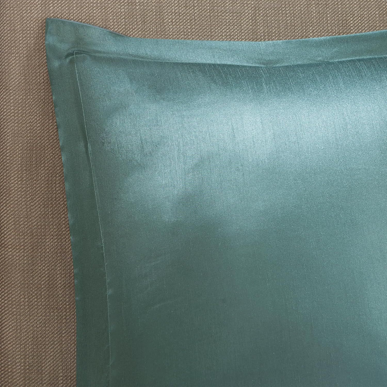 Shows a clean view of the solid teal pillow sham on a neutral background to highlight the fabric color and texture.