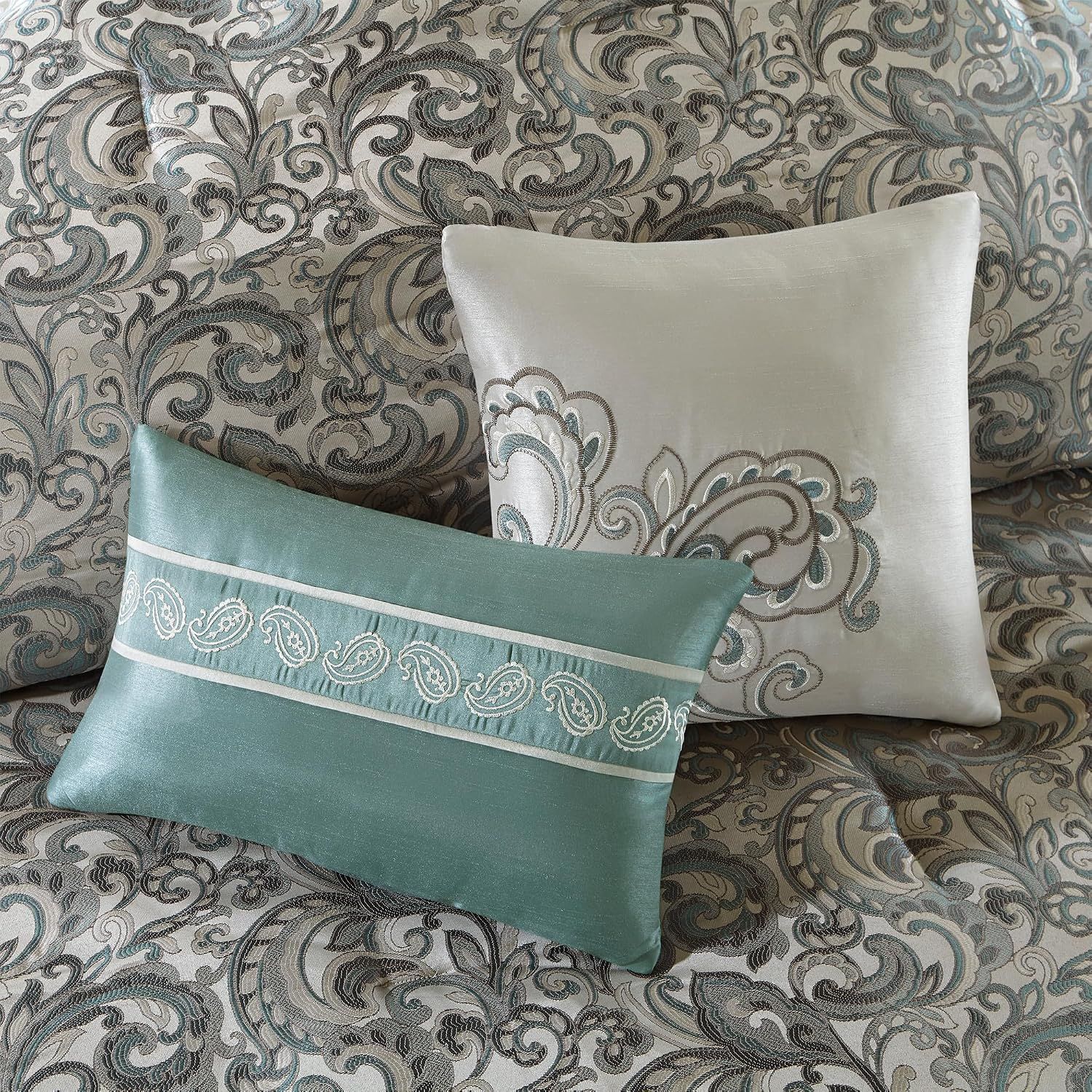 Provides a detailed view of the decorative pillows showing embroidery and design details on the bedding.