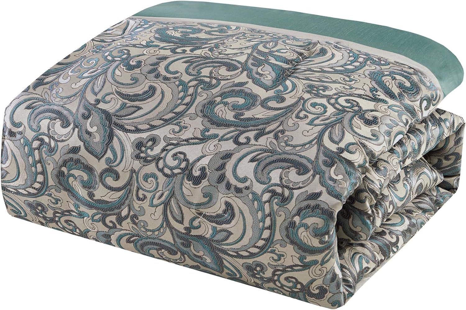 Shows the folded comforter to display the reversible design and overall pattern of the bedding set.