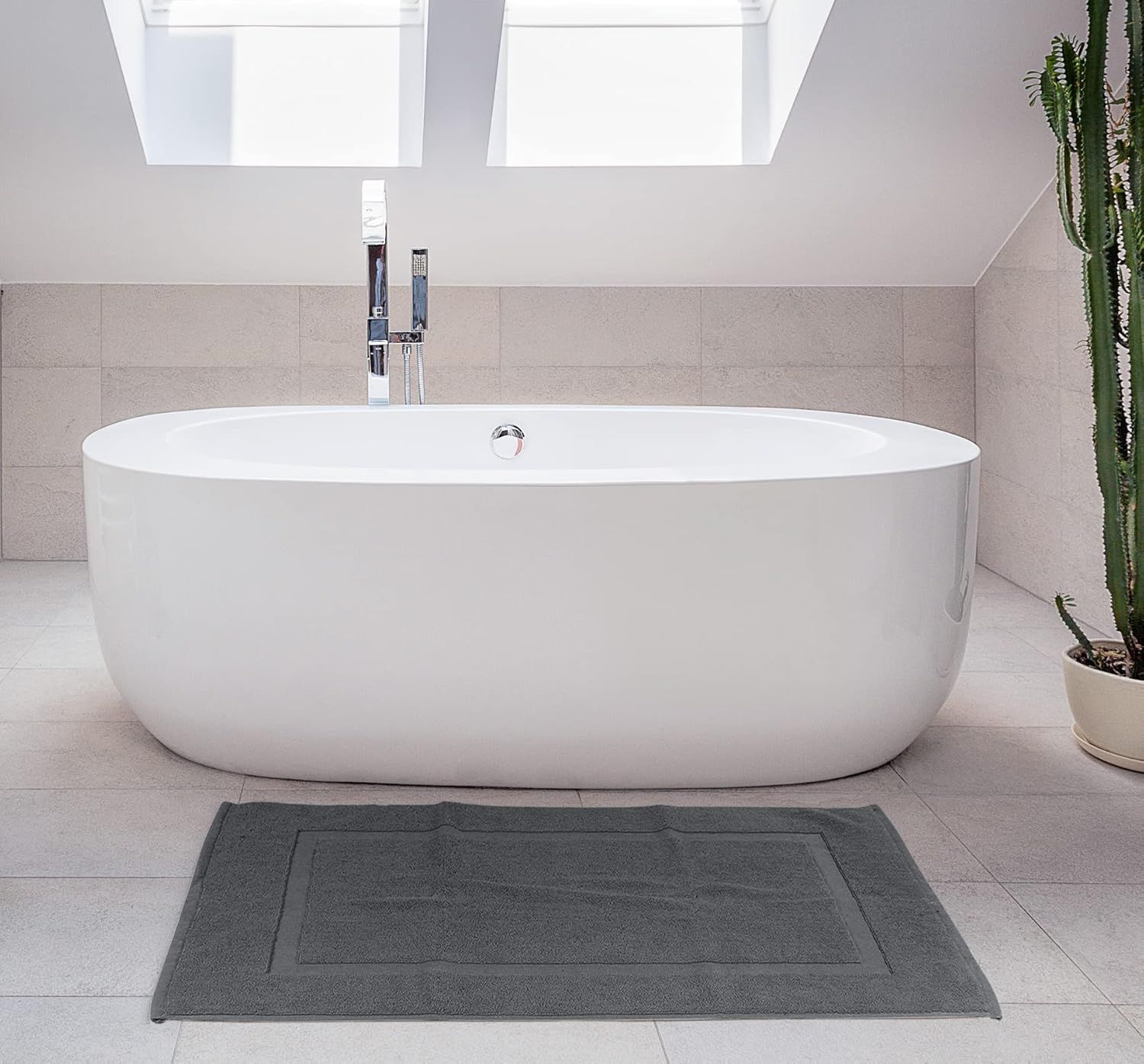 Showcases the bath mat in an upscale bathroom with a freestanding tub, emphasizing its premium aesthetic and design appeal.