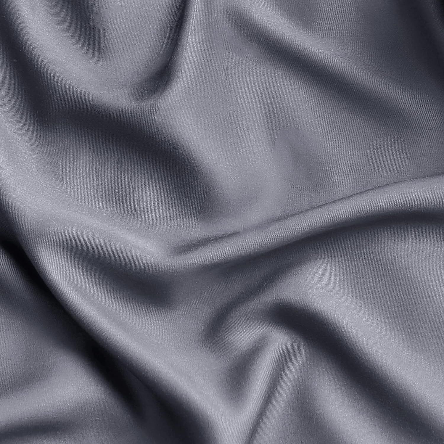 Showcases the luxurious silky texture and quality of the sheet fabric in a close-up detail shot.
