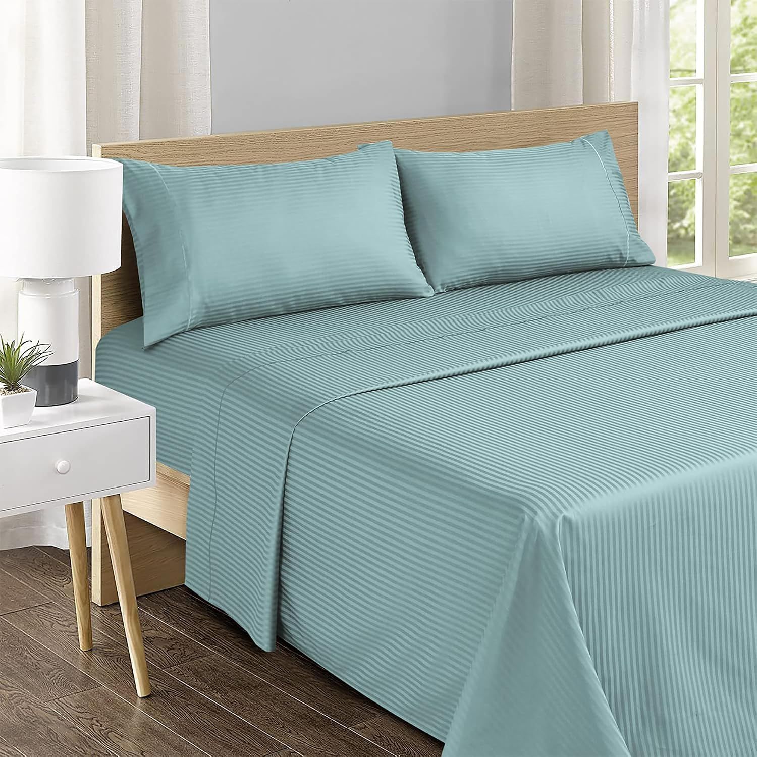 Shows the sheet set styled on a bed in a real bedroom environment to help shoppers visualize the product in their own home.