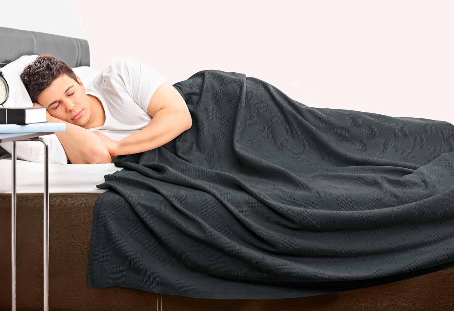 Depicts a person sleeping peacefully under the blanket, communicating comfort and warmth for restful sleep without any text overlay.