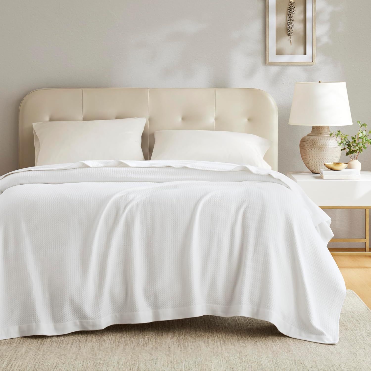 Shows the blanket styled in a real bedroom environment to help shoppers visualize the product in their own home.