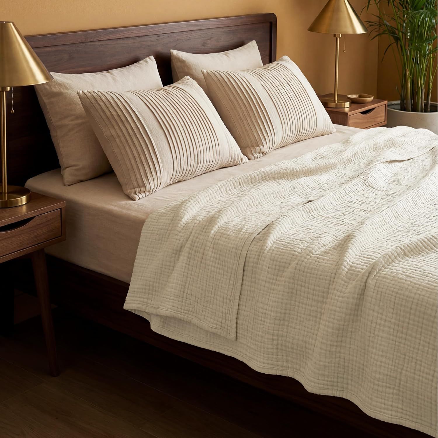 Shows the blanket styled on a bed in a real bedroom environment to help shoppers visualize the product in use.