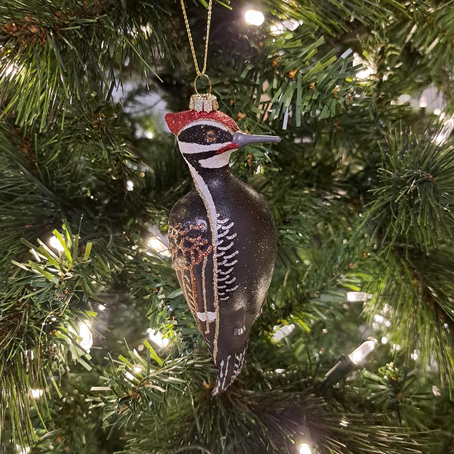 Shows the ornament in its natural use context on a decorated Christmas tree to help shoppers visualize it in their own holiday decor.