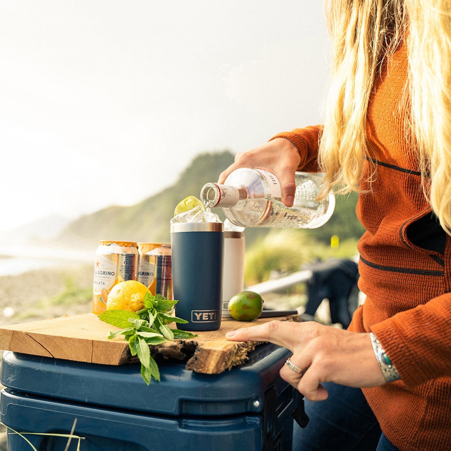 Shows the tumbler in a real-world outdoor setting to help shoppers visualize using the product during leisure activities.