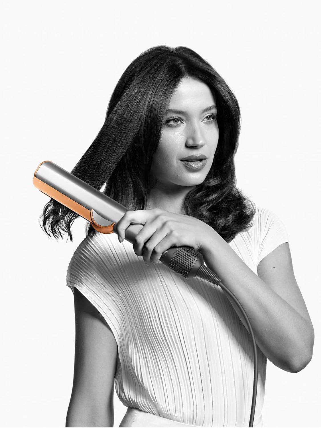 Shows the product being used in a real-world context to help shoppers visualize themselves using the styling tool.