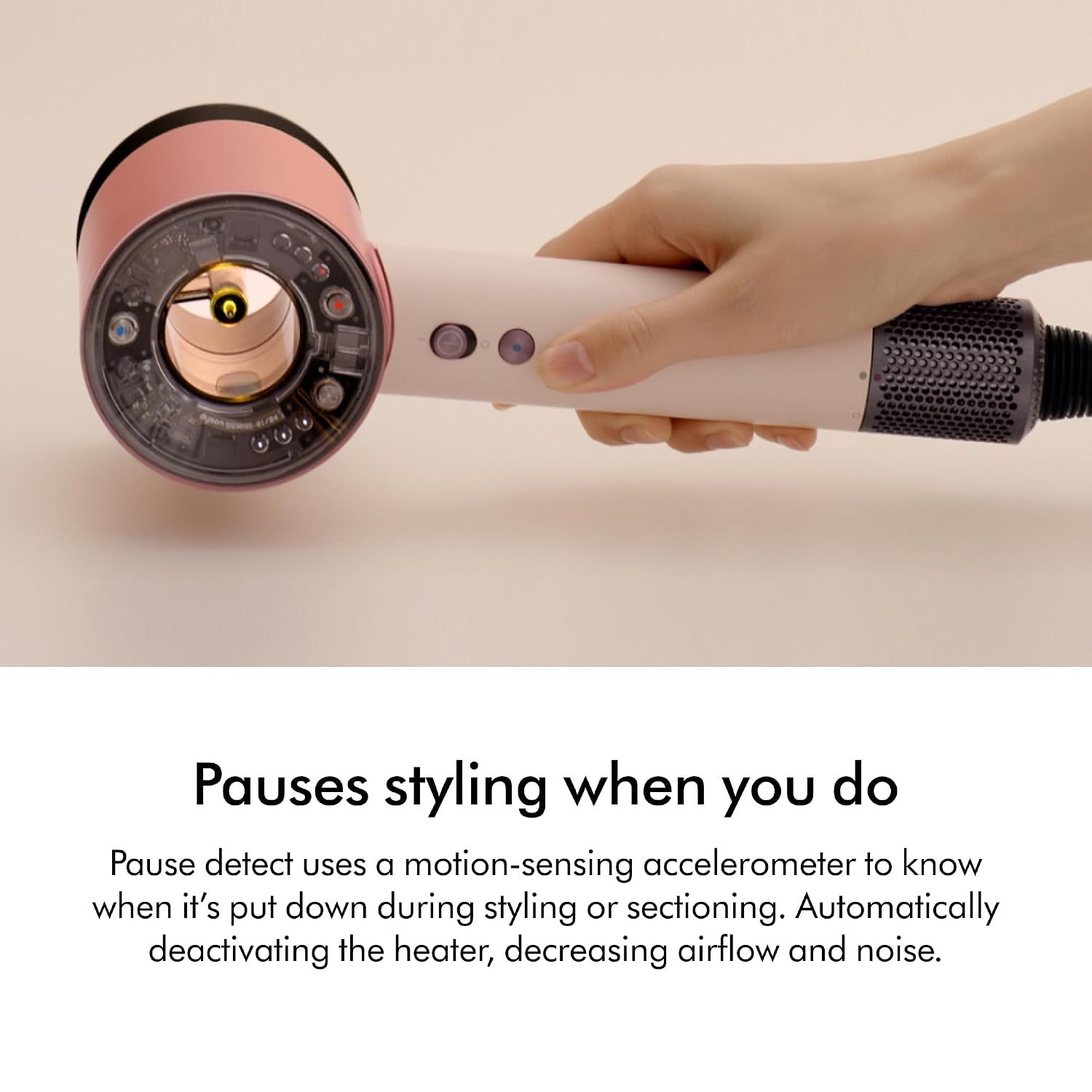Highlights the motion-sensing pause feature that automatically deactivates the heater and reduces airflow when the dryer is put down, improving convenience and safety.