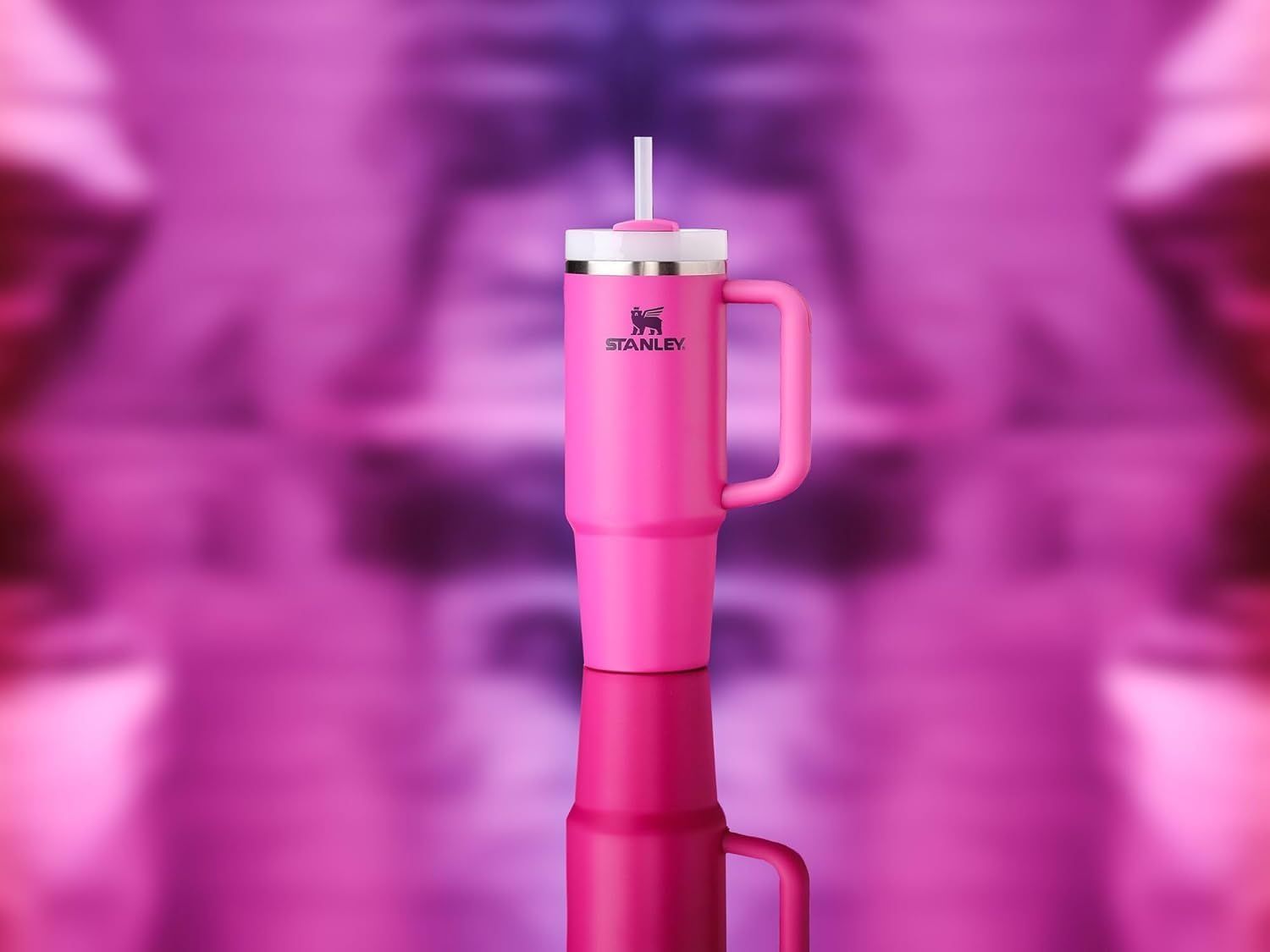 Showcases the product in an artistic, visually appealing setting with a reflective surface and blurred pink background to create an aspirational lifestyle aesthetic.