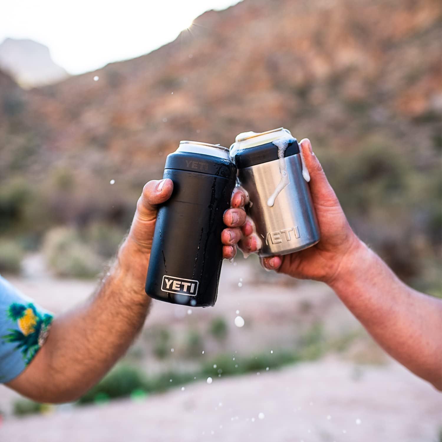 Shows the product in a real-world outdoor social setting with two people toasting, helping shoppers visualize using the colsters during outdoor activities.