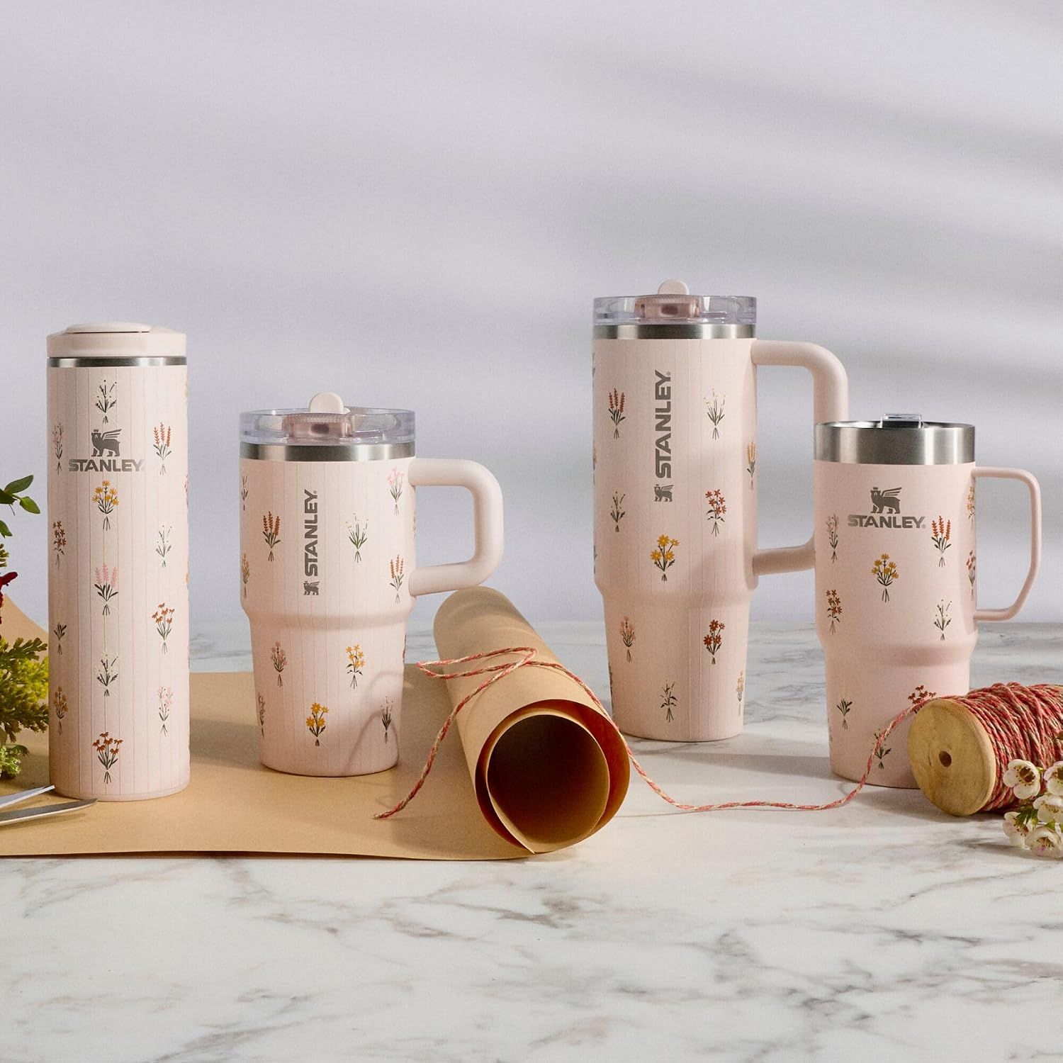 Displays multiple Stanley Quencher products from the same decorative collection in various sizes and styles, helping shoppers understand the available options within the product family.