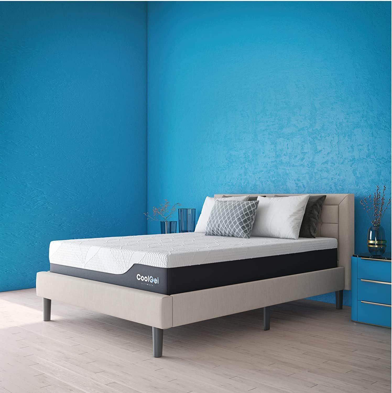 Presents the mattress in a contemporary bedroom with bold blue walls, allowing shoppers to see the product in a real-world setting.