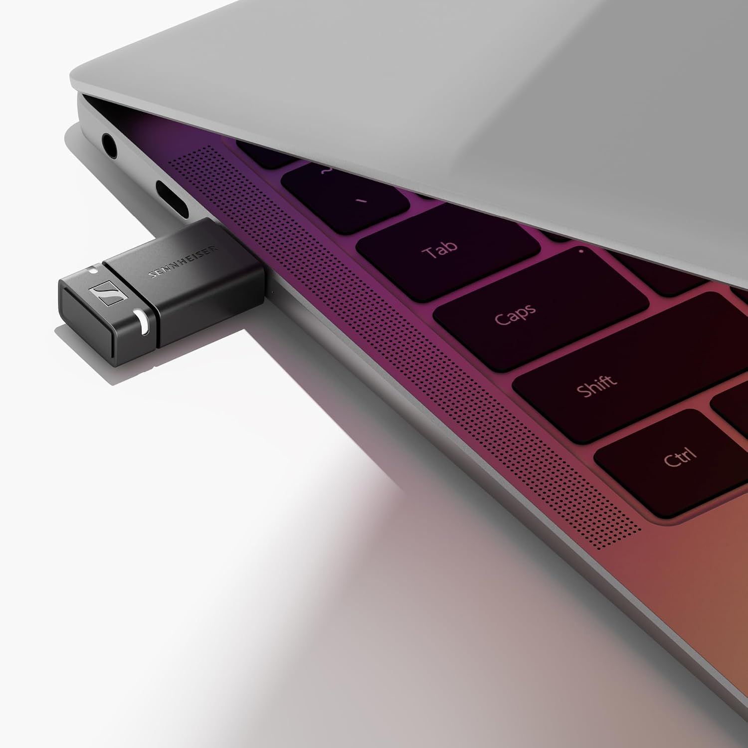 Shows the dongle plugged into a laptop in a real setup so shoppers see how easily it connects.