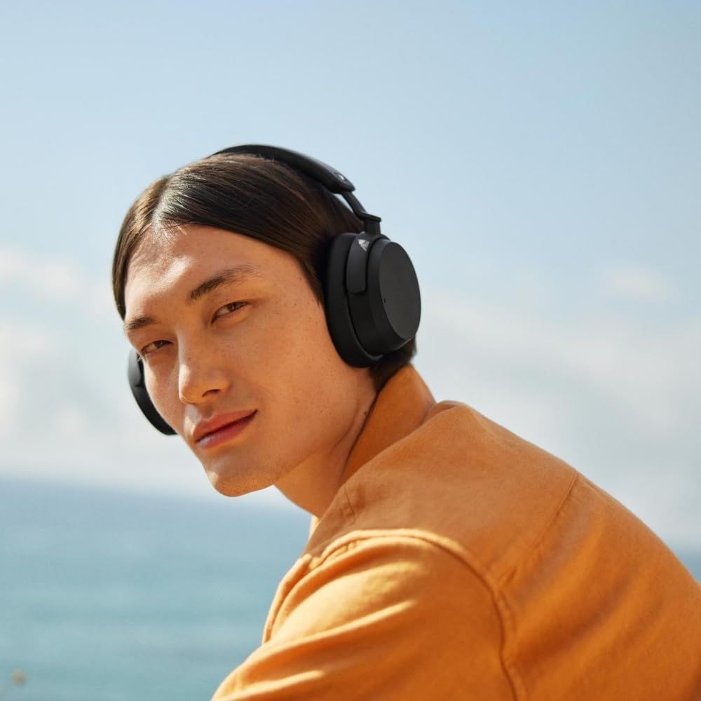 Shows a real person wearing the headphones outdoors so shoppers can picture using them in daily life.