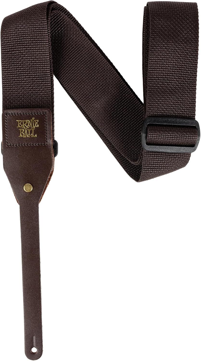 Shows the strap tab fitted to a guitar headstock so shoppers see how it attaches. Reassures shoppers that the strap fits a standard acoustic guitar without extra hardware.